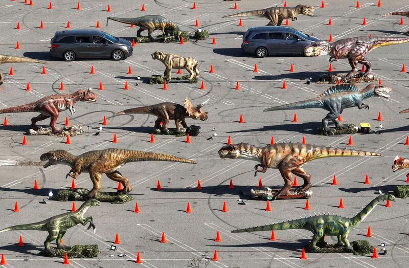 Visitors to Jurassic Empire drive past 30 animatronic dinosaurs in the car park at the Westminster Mall in California. AP