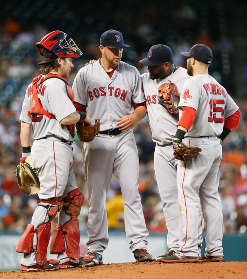 Pablo Sandoval, second from right, is a likely candidate to be traded if the Red Sox can find a taker on his expensive contract, but longtime fan favourite Dustin Pedroia, right, will probably not be moved as Boston management tears down the 2015 edition to start building the 2016 one.  Bob Levey / AFP