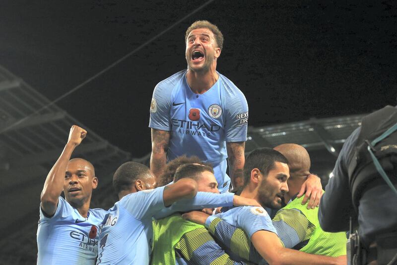 Manchester City's German midfielder Ilkay Gundogan celebrates after scoring their third goal during the English Premier League football match between Manchester City and Manchester United at the Etihad Stadium in Manchester, north west England, on November 11, 2018. (Photo by Lindsey PARNABY / AFP) / RESTRICTED TO EDITORIAL USE. No use with unauthorized audio, video, data, fixture lists, club/league logos or 'live' services. Online in-match use limited to 120 images. An additional 40 images may be used in extra time. No video emulation. Social media in-match use limited to 120 images. An additional 40 images may be used in extra time. No use in betting publications, games or single club/league/player publications. / 