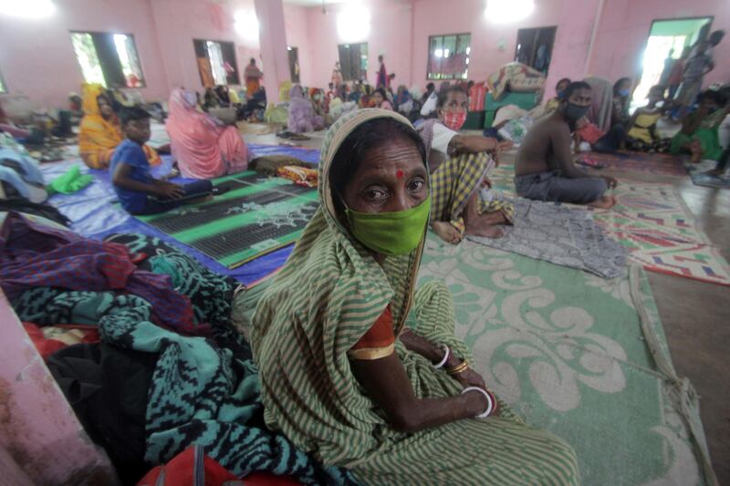 People sit in a temporary cyclone relief shelter at Paradeep, Odisha, India. EPA