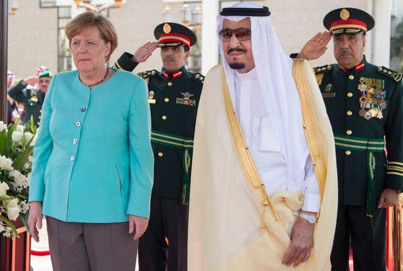 German Chancellor Angela Merkel, left, is received by Saudi King Salman on her arrival to Jeddah, Sunday, April 30, 2017. (Saudi Press Agency via AP)