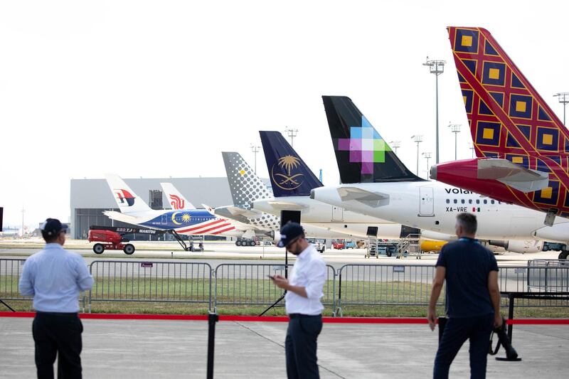 Plane tails decorated in different livery stand as Airbus SE unveil the new A220 single-aisle aircraft in Toulouse, France, on Tuesday, July 10, 2018. Airbus renamed the C Series jet acquired from Bombardier Inc. the A220 and set a target of at least 100 orders for the aircraft this year. Photographer: Christophe Morin/Bloomberg