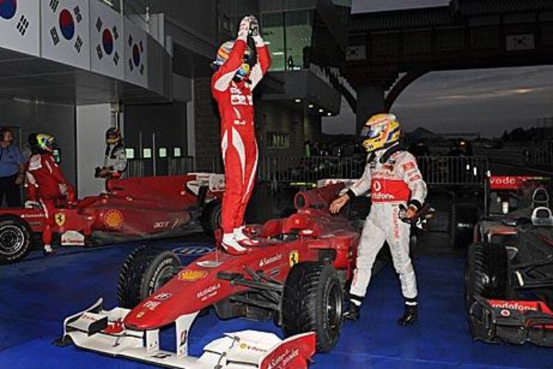 Fernando Alonso stands on his car as he celebrates winning the Korean  Grand Prix and taking the lead in the drivers’ table.