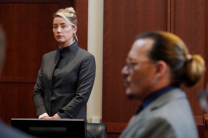 Actors Amber Heard and Johnny Depp watch as the jury leaves the courtroom for a lunch break at the Fairfax County Circuit Courthouse in Fairfax, Virginia, on May 16. AP Photo
