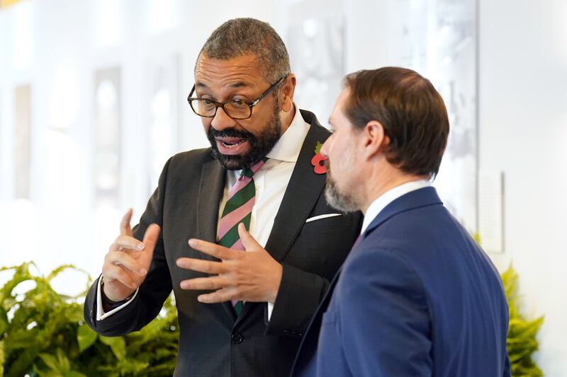 British Foreign Secretary James Cleverly talks to an attendee. The summit is being attended by industry leaders and government officials. PA