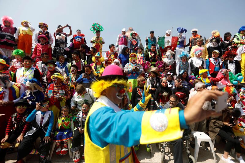 A clown takes a selfie in front of other clowns during the 22nd Latin American clown convention at Revolucion monument in Mexico City, Mexico. Edgard Garrido / Reuters