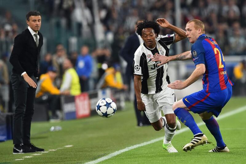 Barcelona defender Jeremy Mathieu, right, vies for possession with with Juventus forward Juan Cuadrado. Giuseppe Cacace / AFP