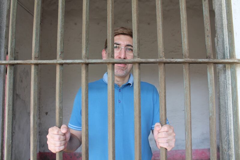 Hashmi photographed in the cell where his grandfather was imprisoned in 1951