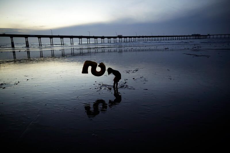 Nora Belverud plays on a beach in low-tide in San Diego, California. Gregory Bull / AP Photo