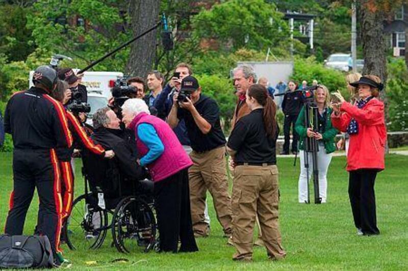 Former first lady Barbara Bush greets her husband and former US president George HW Bush with a kiss after his successful skydive down to St. Anne's Episcopal Church. Eric Shea/Getty Images/AFP