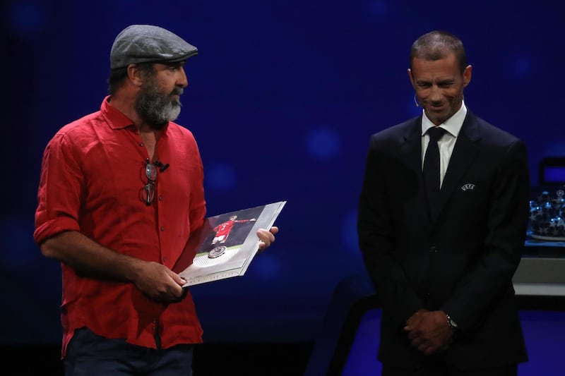 Former French international Eric Cantona, left, receives the Uefa President's Award. AFP