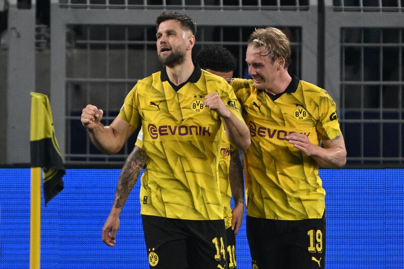 Niclas Fullkrug and Julian Brandt celebrate after Dortmund take a 1-0 lead against PSG. PA