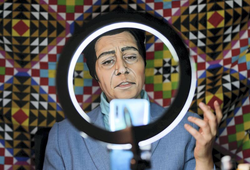 Alaa Bliha, a Jordanian artist using make-up to transform into celebrities, records a video while imitating the late artist and singer Farid al-Atrash, at her home in Amman, Jordan December 27, 2020. Picture taken December 27, 2020. REUTERS/Muhammad Hamed