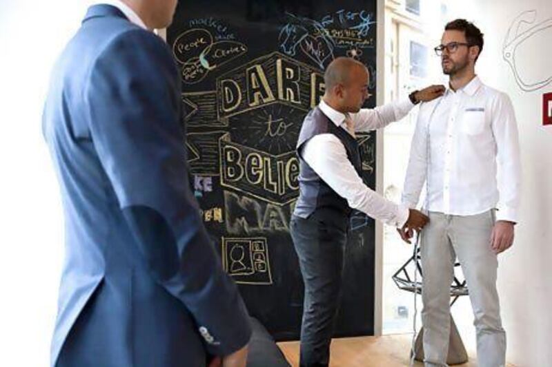 Tarig El-Sheikh, co-founder of Knot Standard, measures up Leith Matthews, managing director of MAKE Business Hub, for a suit that they are designing for him. ANTONIE ROBERTSON / The National