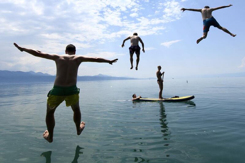 People enjoy the sunny weather on Lake Geneva, in Lutry, south-west Switzerland.  Laurent Gilleron / EPA