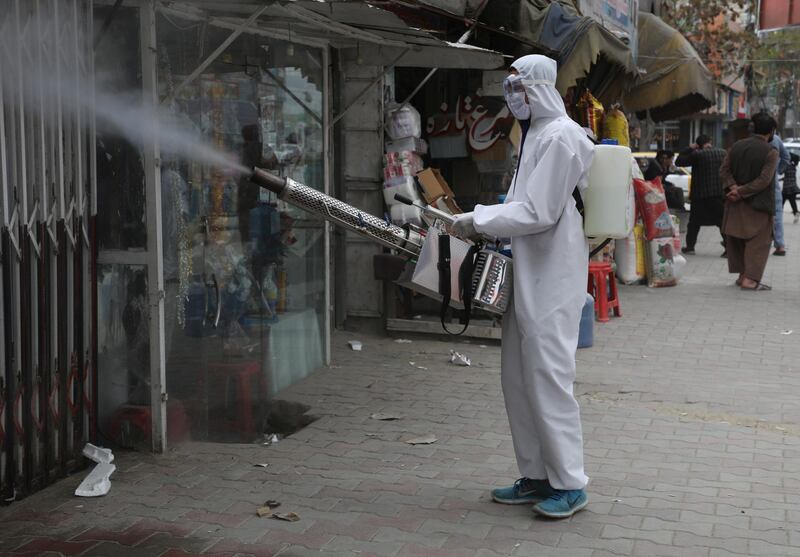 An Afghan National Procurement Authority worker sprays disinfectant in Kabul, Afghanistan. Reuters
