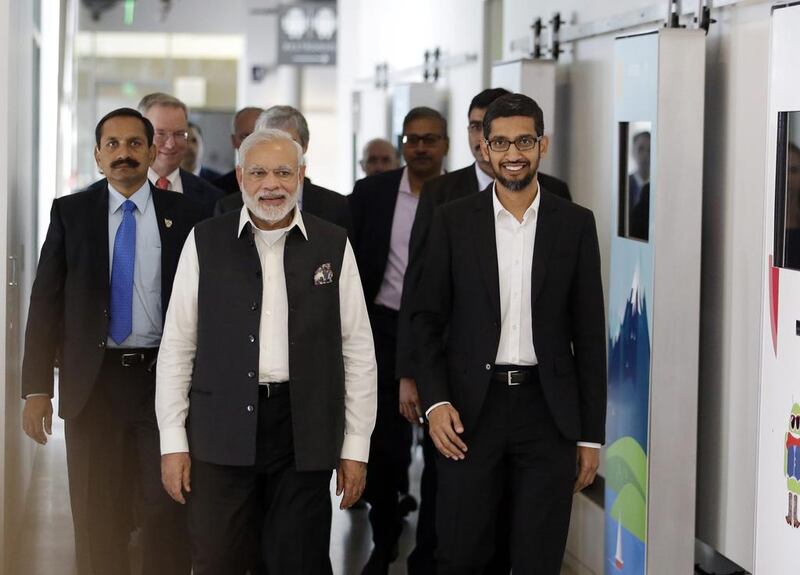 Narendra Modi, centre, walks the hallways of Google headquarters alongside Google executive Sundar Pichai, right, on Sunday, September 27, 2015, in Mountain View, California. After meeting with Facebook CEO Mark Zuckerberg at Facebook headquarters, Mr Modi scheduled meetings with the CEOs of Apple and Google during his whirlwind tour of Silicon Valley. Marcio Jose Sanchez / AP Photo