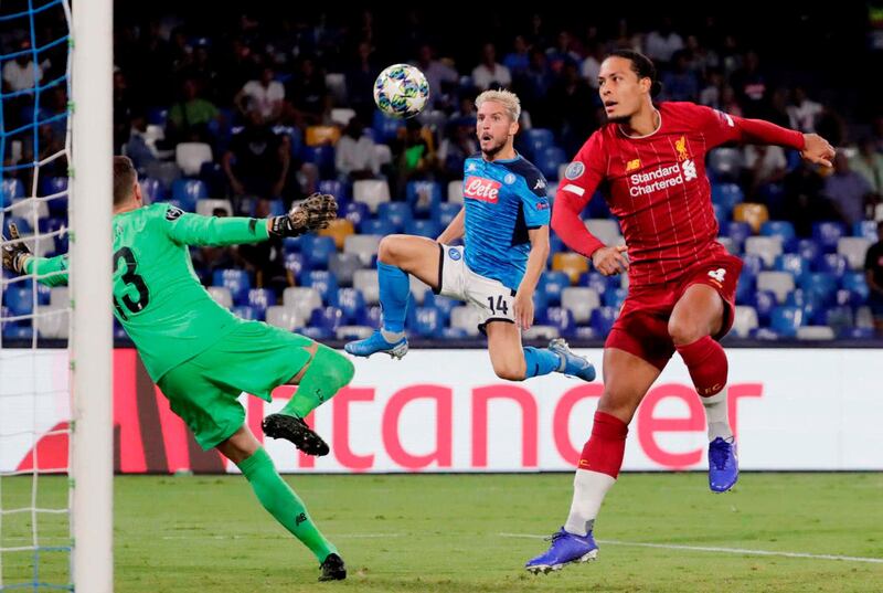 Napoli's Dries Mertens in action with Liverpool's Virgil van Dijk and Adrian. Reuters