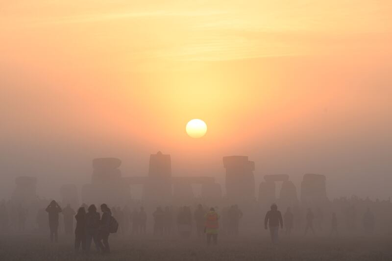 Revellers celebrate the summer solstice as the sun rises for the longest day of the year at Stonehenge, near Amesbury, in Wiltshire, southern England. AFP
