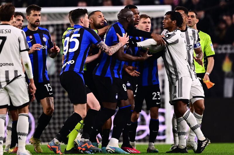 Inter Milan’s Romelu Lukaku, centre, argues with Juventus’ Juan Cuadrado during the Coppa Italia semi-final first leg at the Allianz Stadium in Turin on Tuesday, April 4, 2023. AFP