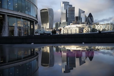 Office buildings of the City of London are reflected in a puddle. The IHS Markit/CIPS services Purchasing Managers’ Index for the UK fell to a four month low of 51.4 in October from 56.1 in September. AFP