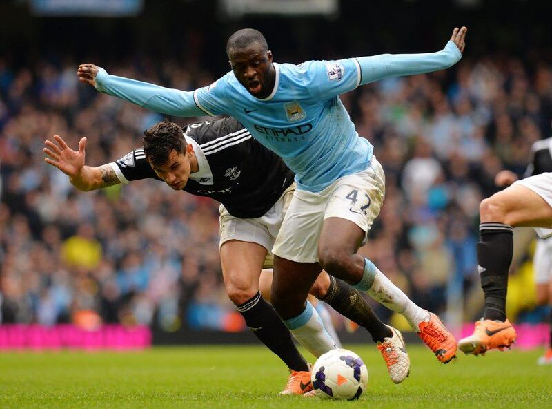 Yaya Toure of Manchester City is challenged by Jose Fonte of Southampton during their Premier League match on Saturday. Shaun Botterill / Getty Images / April 5, 2014