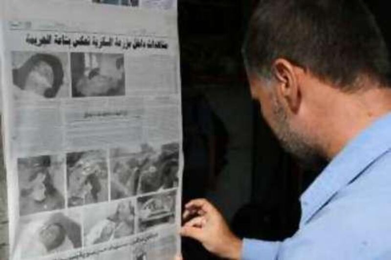 A Syrian man, posts a newspaper outside his shop covering news of the recent US raid at the Syrian-Iraqi border, in Damascus, Syria, on Tuesday Oct. 28, 2008.  The deadly U.S. raid into Syria may complicate efforts to win approval for a new U.S.-Iraqi security deal. Syrian officials say U.S. troops and helicopters launched the raid Sunday inside Syrian territory close to the Iraqi border, killing eight people.(AP Photo/Bassem Tellawi) *** Local Caption ***  DAM102_Mideast_Syria_US_Raid.jpg