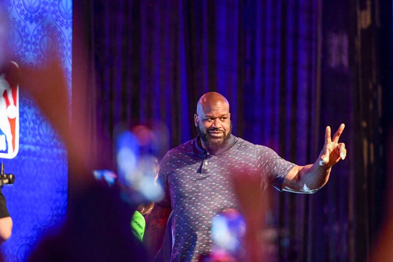 Former basketball champion Shaquille O'Neal makes his way to the stage.
