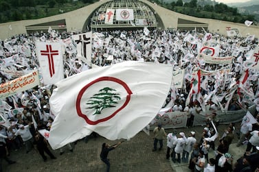 Lebanese supporters of the head of the outlawed Lebanese Forces militia, Christian leader Samir Geagea, protest 23 April 2005 in Bkerke to demand the release of the jailed former Christian warlord during the 11th anniversary of his arrest. Geagea was jailed after being accused of carrying out a 1994 church bombing that killed 11 people north of Beirut. He was later found not guilty of the attack but remained in jail after being sentenced to death for other cases, including the assassinations of rival Christian leaders. AFP PHOTO/JOSEPH BARRAK (Photo by JOSEPH BARRAK / AFP)