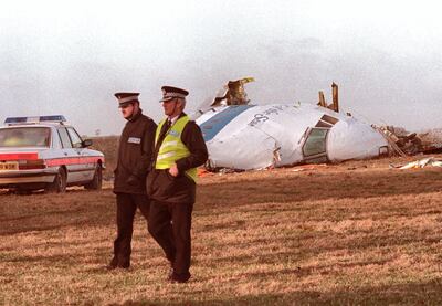 picture dated 21 December 1988 showing two British policemen walking past the wreck of the ill-fated US-bound Pam Am Boeing747 which blew over Lockerbie, Scotland, killing 270 people, including 11 on the ground. Two Libyan agents were then accused of masterminding the attack of the plane. The Dutch government said 24 August that it would cooperate fully with Britain and the United States over the possibility of trying the two suspects Lockerbie bombers in the Netherlands. (Photo by ROY LETKEY / AFP)