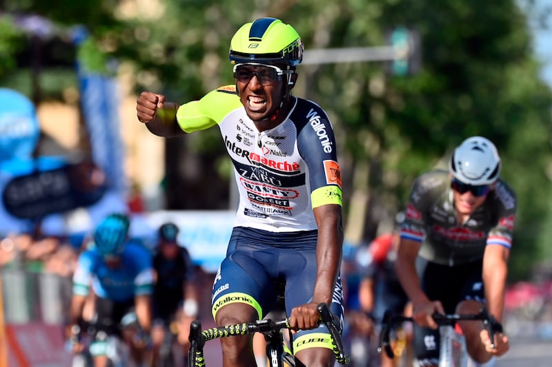 Eritrea's Biniam Girmay celebrates as he  crosses the finish line of the 10th stage of the Giro D'Italia cycling race from Pescara to Jesi, Italy,  Tuesday, May 17, 2022.  (Massimo Paolone / LaPresse via AP)