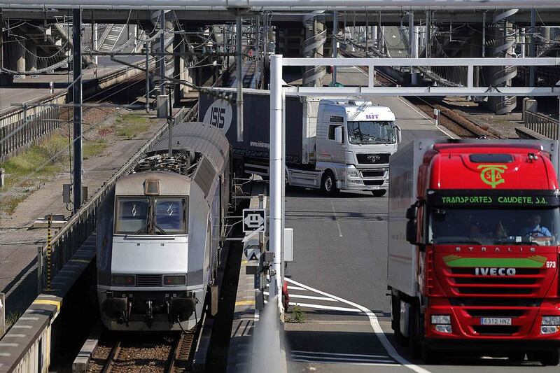 Trucks are unloaded from a Eurotunnel freight train after crossing the Channel Tunnel in Coquelles. The tunnel project cost £4.65 billion to build, 80 per cent more than expected. Christian Hartmann / Reuters