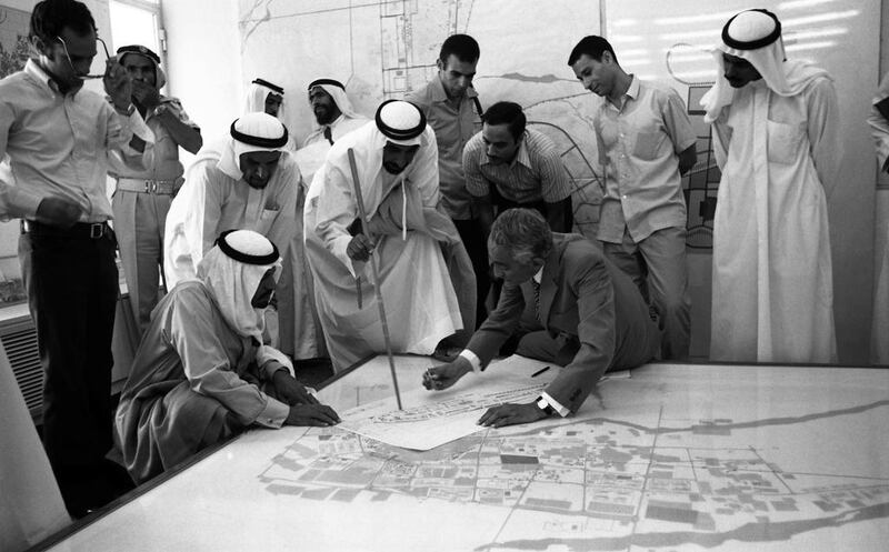 Sheikh Zayed examines a plan of Abu Dhabi with the architect Dr Abdul Rahman Makhlouf at the Ministry of Municipalities and Agriculture in the 1970s.
