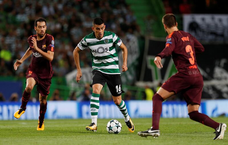 Sporting’s Rodrigo Battaglia takes on Barcelona’s Sergio Busquets. Pedro Nunes / Reuters