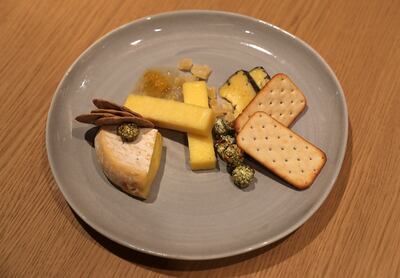 The Kapiti Moana cheese platter at Tiaki features dehydrated pineapple, seaweed-seasoned popcorn, honeycomb and crackers. Pawan Singh / The National 