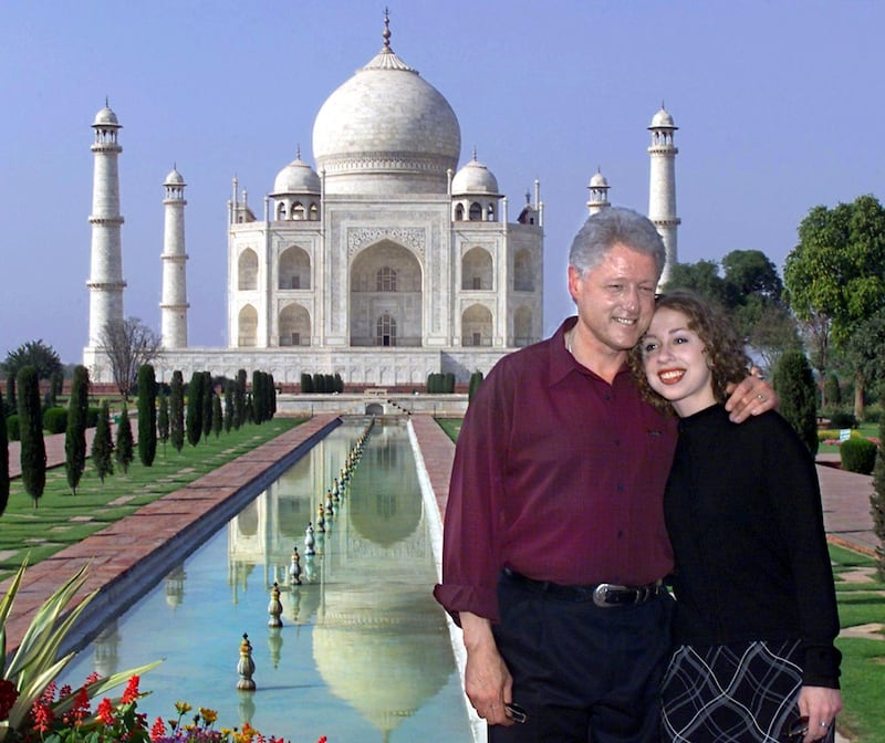 US President Bill Clinton and his daughter Chelsea tour the grounds of one of the Seven Wonders of the World, India's Taj Mahal, 22 March 2000 in the city of Agra. The Taj Mahal was completed in 1648 as a tribute to Mughal Emperor Shah Jahan's wife, Mumtaz Mahal, who died giving birth to his 14th child.      (ELECTRONIC IMAGE) (Photo by PAUL J. RICHARDS / AFP)
