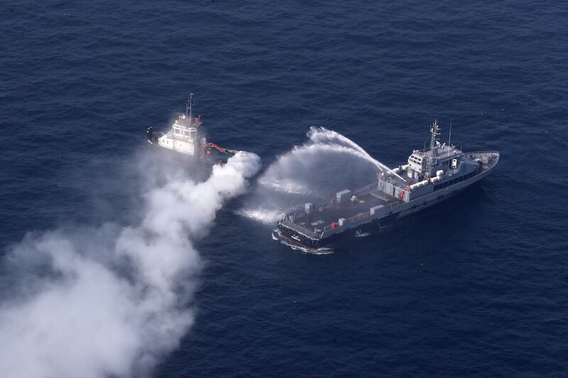 Military warships tackle a fire during the joint exercise.