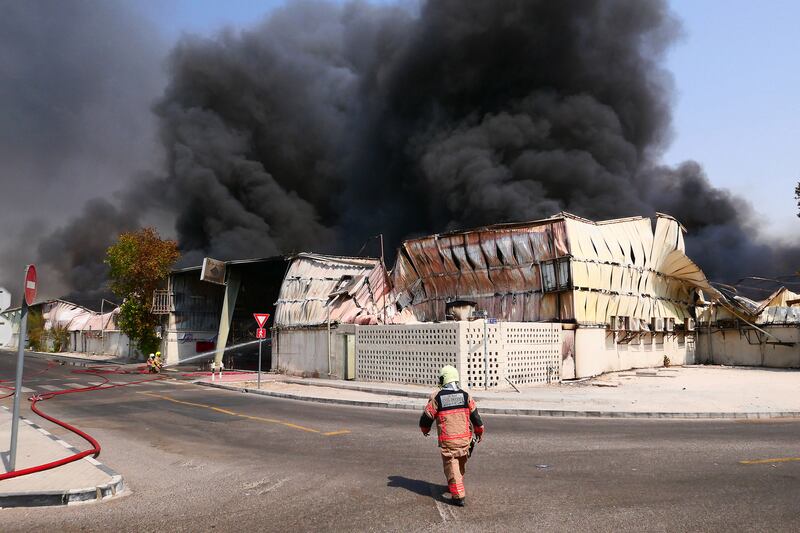 Firefighters control a blaze at a warehouse behind Al Kabayel Discount Centre in Deira, Dubai. Pawan Singh / The National.