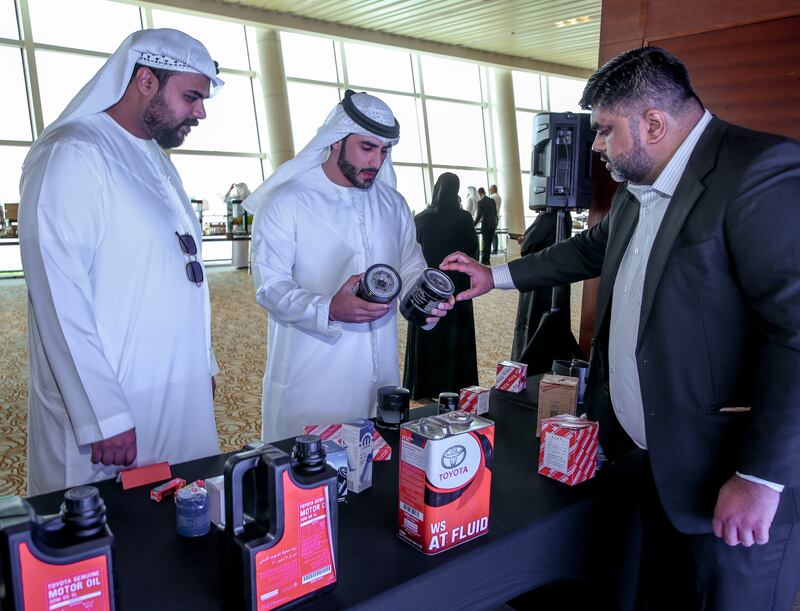Kamran Sarwar, right, Al-Futtaim Automotive Brands protection manager with samples of fake oil filters. Victor Besa / The National