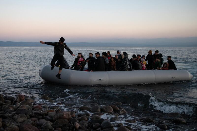 Migrants from Afghanistan arrive on a dinghy on a beach near the village of Skala Sikamias, after crossing part of the Aegean Sea from Turkey to the island of Lesbos, Greece, March 2, 2020. REUTERS/Alkis Konstantinidis