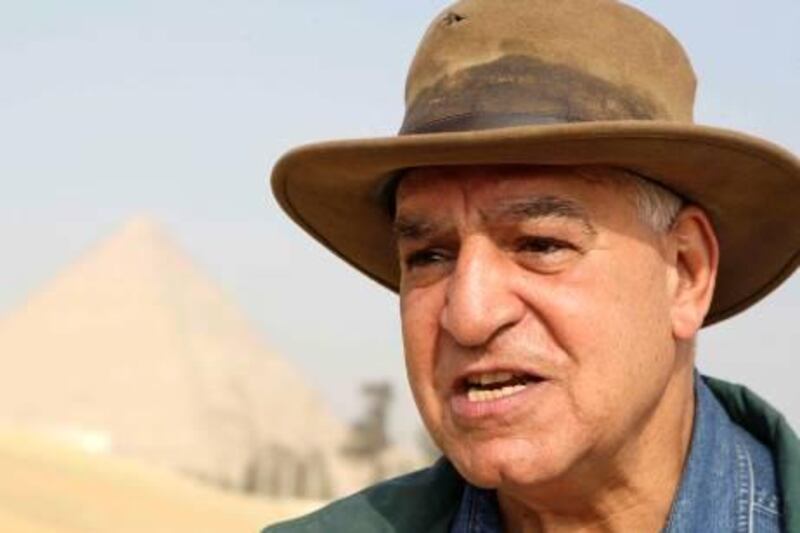 Egypt's chief archaeologist Zahi Hawass speaks at a site where a new collection of tombs has been found next to the biggest pyramid of Khufu, January 11, 2010.  New tombs found in Giza support the view that the Great Pyramids were built by free workers and not slaves, as widely believed, Egypt's chief archaeologist heading the Egyptian excavation team, Zahi Hawass, said on Sunday. REUTERS/Tarek Mostafa (EGYPT - Tags: SOCIETY) *** Local Caption ***  CAI106_EGYPT-_0111_11.JPG