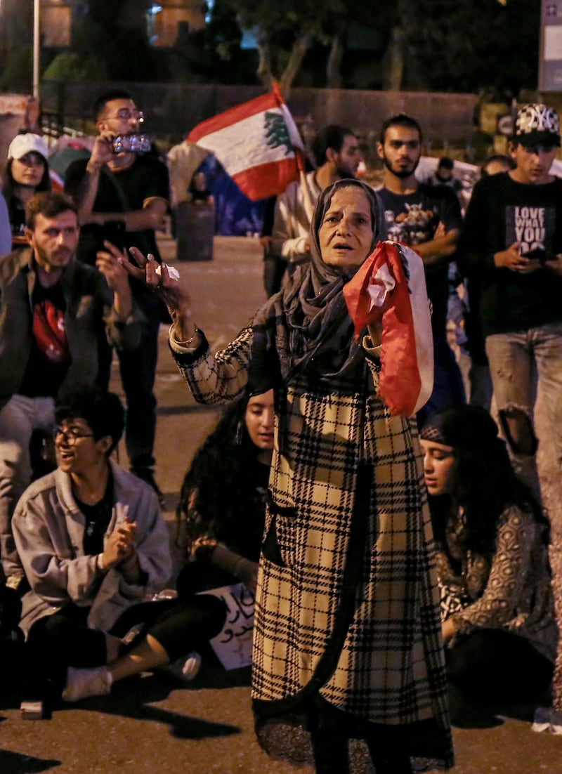 Protesters chant and dance on national songs during ongoing anti-government protests in front the government palace in downtown Beirut, Lebanon.  EPA