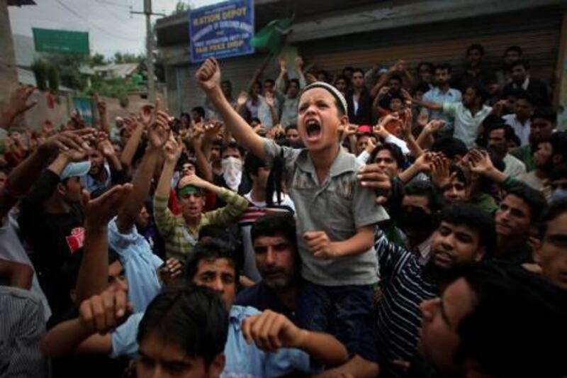 A young Kashmiri boy shouts slogans during a protest on the outskirts of Srinagar, India, Monday, Sept. 13, 2010. Indian forces battled Kashmiri protesters in the streets of the disputed territory Monday in demonstrations fueled in part by a report of the Quran being desecrated in the United States. (AP Photo/Altaf Qadri) *** Local Caption ***  38e859c9da904007ac6bd1173beec8ef-38e859c9da904007ac6bd1173beec8ef-0.jpg