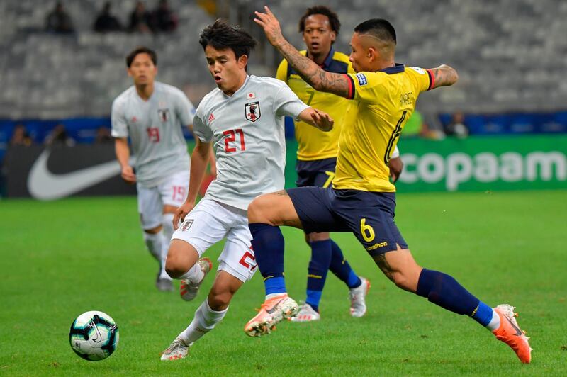 Japan's Takefusa Kubo, left, and Ecuador's Cristian Ramirez vie for the ball during their 2019 Copa America Group C match at the Mineirao Stadium in Belo Horizonte, Brazil. The match ended in a 1-1 draw, eliminating both teams. AFP