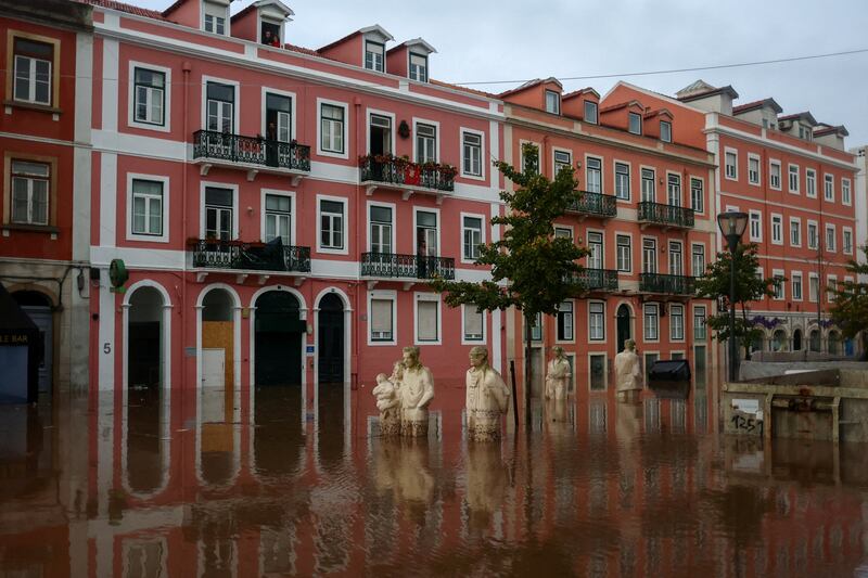 Submerged statues on a flooded street in Alges, Portugal. Reuters