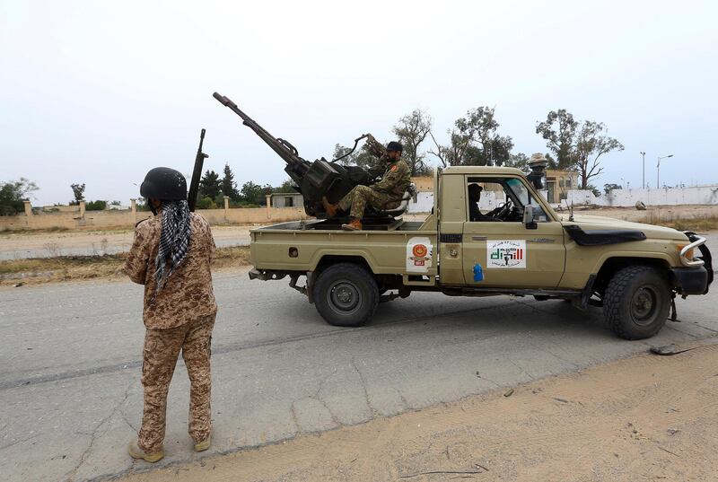 FILE - In this May 21, 2019 file photo, Tripoli government forces clash with forces led by Field Marshal Khalifa Hifter, south of the capital Tripoli, Libya. Two Libyan militia commanders and a Syrian war monitor group say Turkey is deploying Syrian extremists to fight in Libya's civil war. These extremists are affiliated with groups like al-Qaida and the Islamic State. They're fighting as mercenaries on behalf of the United Nations-supported government in Libya. The Libyan sources told The Associated Press that Turkey has airlifted more than 2,500 foreign fighters into Tripoli, and that â€œdozensâ€ are extremist-affiliated. (AP Photo/Hazem Ahmed, File)