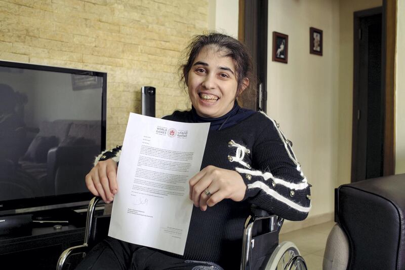 Rita holds her invitation to the Special Olympics held in Abu Dhabi
