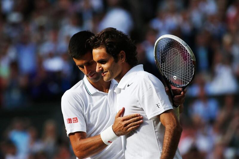 Novak Djokovic and Roger Federer shown together after Djokovic defeated Federer in the final of last year's Wimbledon tournament. Getty Images Photo / July 6, 2014