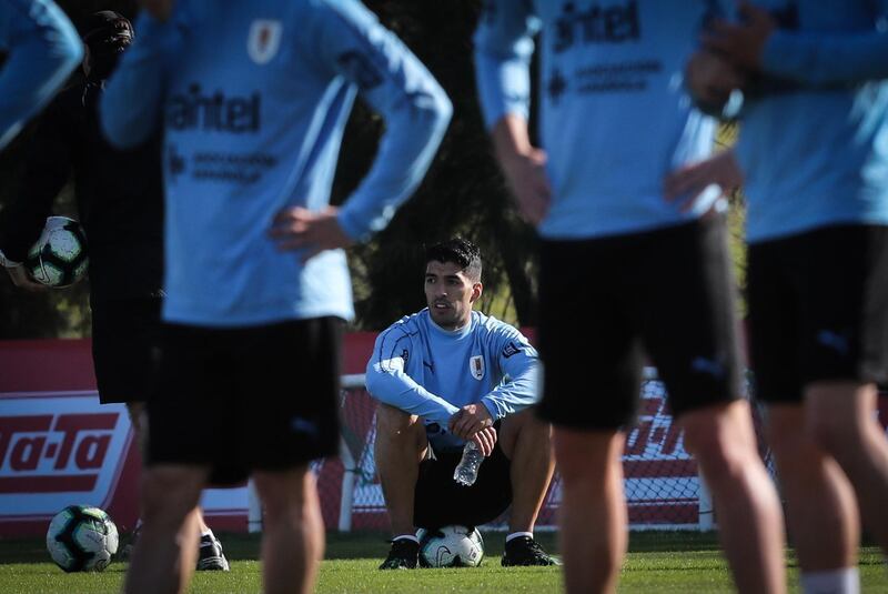 Uruguay striker Luis Suarez sits out a training session with the national team in Montevideo. The Barcelona striker joined up with his teammates last week after undergoing a meniscus on May 10. EPA