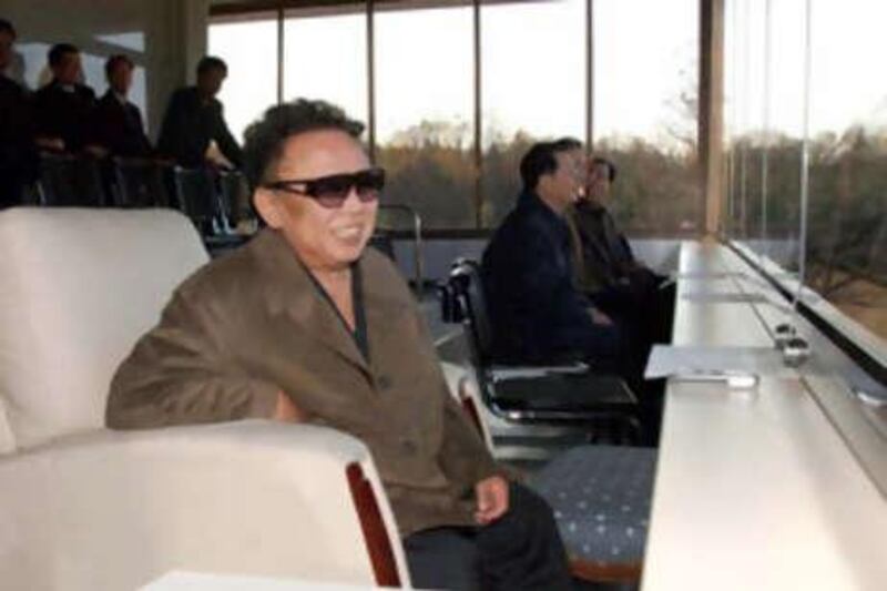 In this undated photo North Korean leader Kim Jong Il, wearing glasses, watches a soccer game between teams of the (north) Korean People's Army.  The news service did not say the date nor place the North Korean leader watched the game.